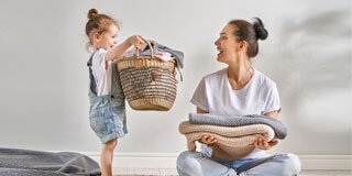 Laundry service — mother and child with laundry basket